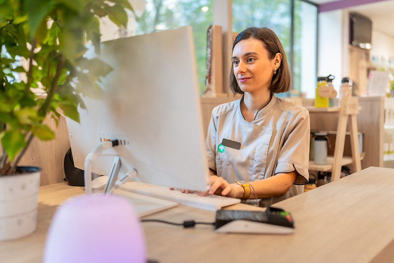 Woman at her desk looking at the computer.